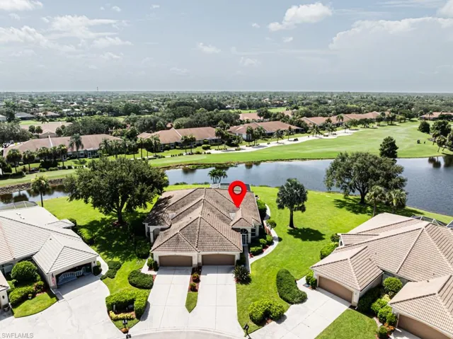 Aerial view of residential area featuring a nearby body of water