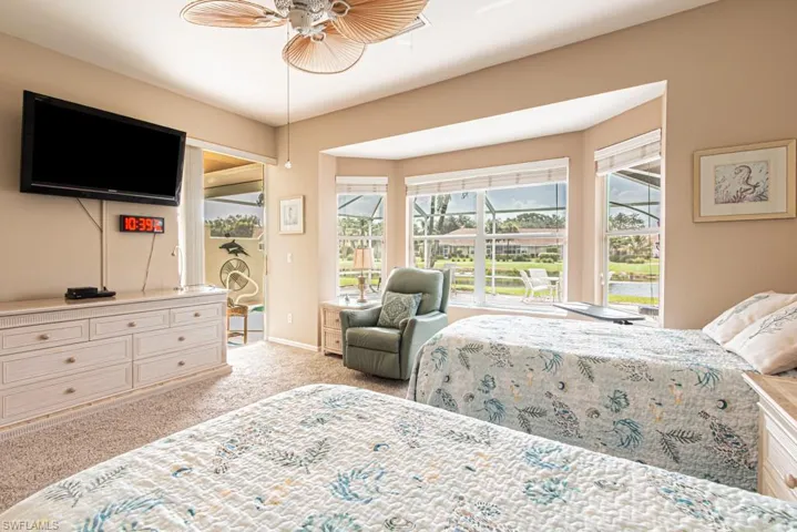 Bedroom with carpet floors, access to outside, and ceiling fan