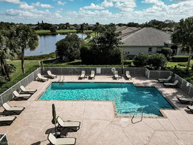 Community pool with a patio area and a water view