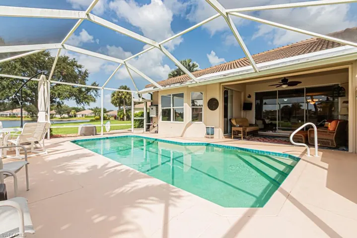 Outdoor pool with a patio area, ceiling fan, a lanai, and an outdoor living space