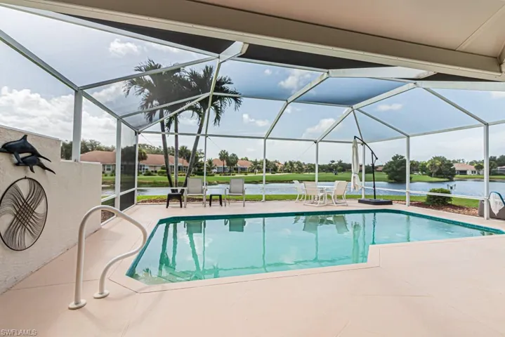 Outdoor pool featuring a patio area, a water view, and a residential view