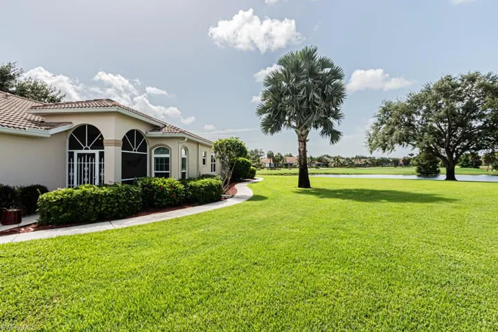 View of grassy yard with a water view