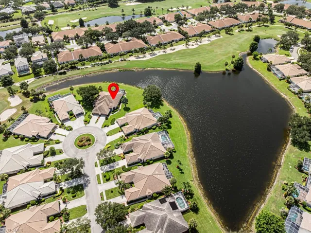Aerial view of property's location with nearby suburban area and a nearby body of water