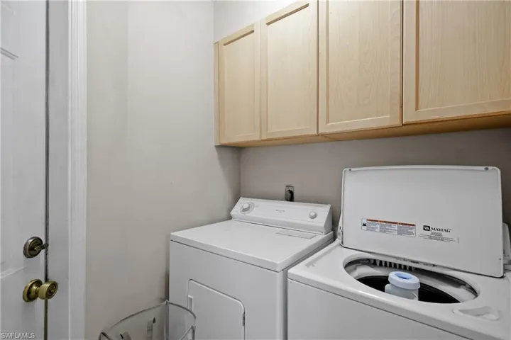 Washroom with washing machine and dryer and cabinet space