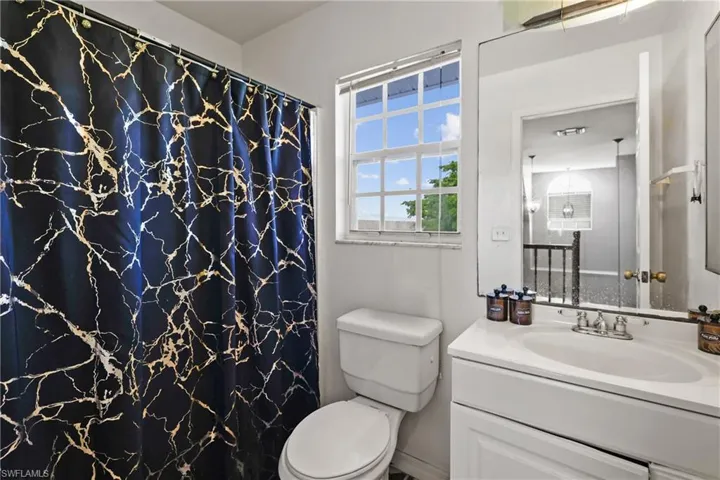 Bathroom featuring vanity and curtained shower