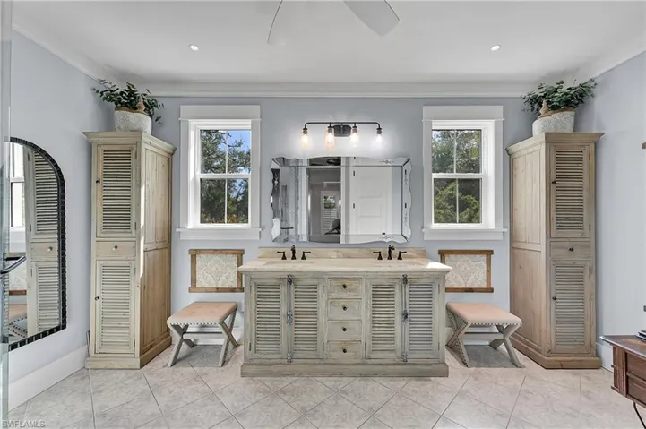 Beautiful primary bathroom with dual vanities, abundant cabinetry, and timeless finishes