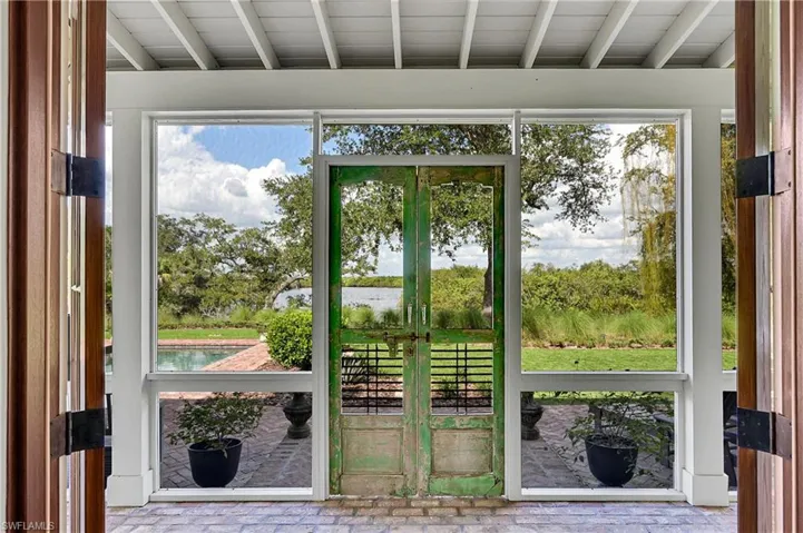 View from the great room showcasing fold-flat French doors that frame tranquil outdoor views, allowing the great room to open fully to the patio for true indoor-outdoor living