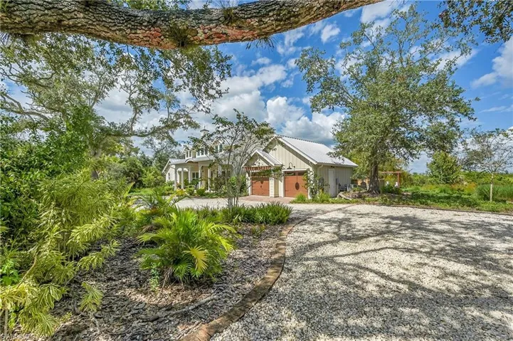 Expansive gravel drive tucked along the side of the home, ideal for boat, RV, or additional guest parking.  Mature trees provide privacy while maintaining easy access to the main residence