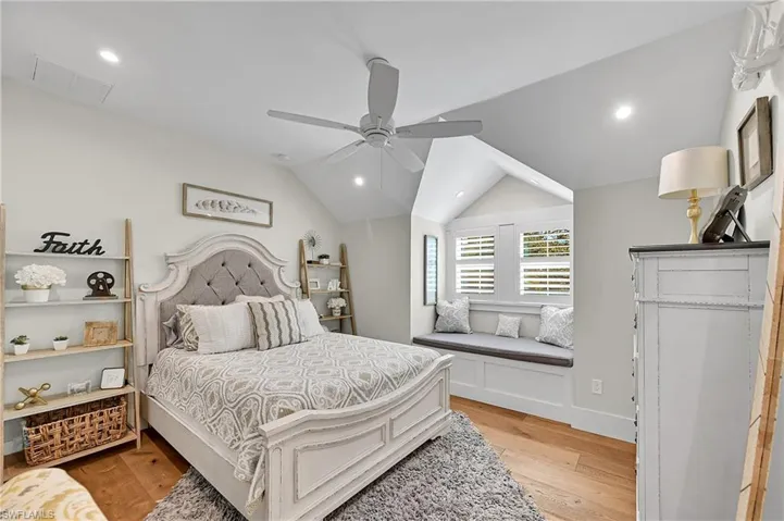 Charming bedroom with built-in window seat creates a cozy nook filled with natural light