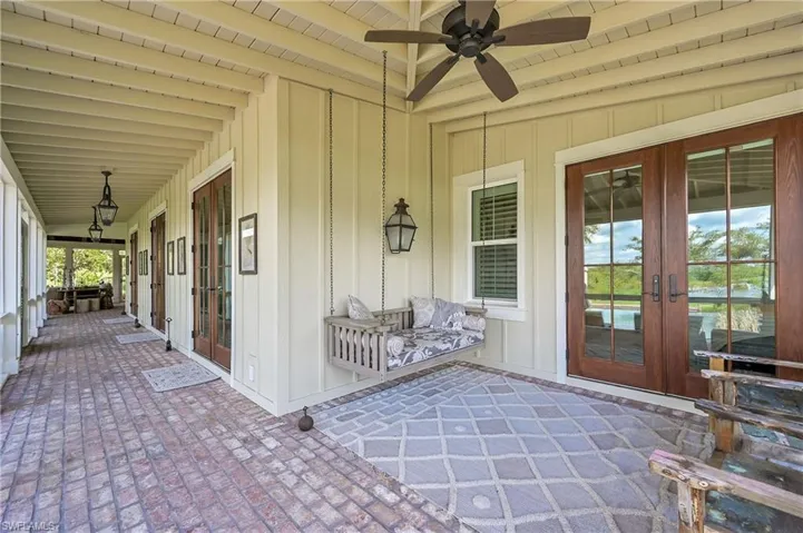 Just outside the primary bedroom, southern charm abounds under the classic covered porch with brick pavers and copper gas lanterns providing timeless character and comfort