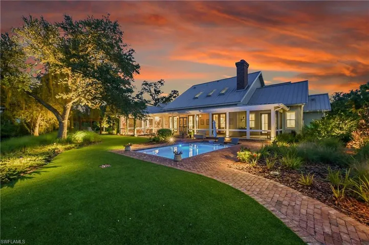 Resort style yard featuring lush synthetic grass