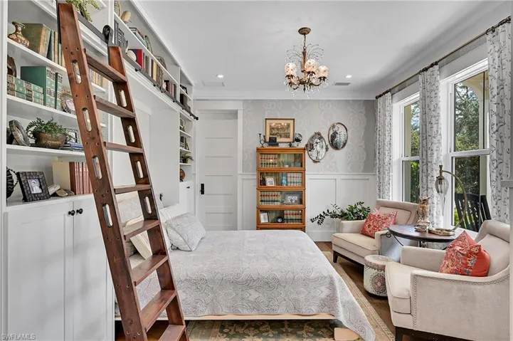Charming library with custom built-in shelves, murphy bed, rolling ladder and elegant chandelier.  Thoughtfully designed to serve as a cozy reading room or elegant guest room