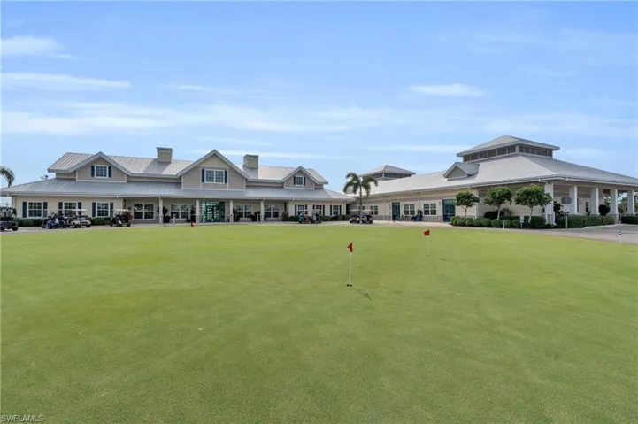 View of community clubhouse and putting green