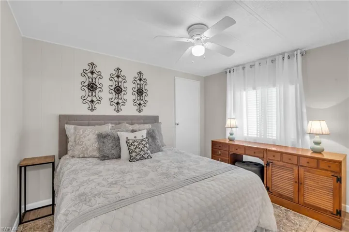 Bedroom featuring ceiling fan and walk-in closet