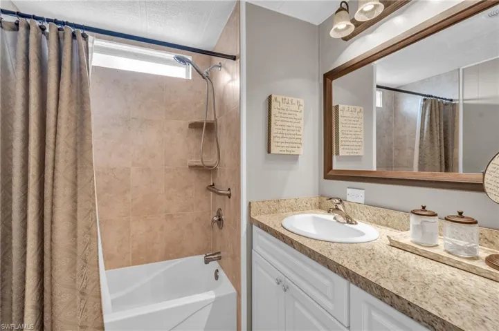 Bathroom with vanity and shower / tub combo with ample storage and pantry