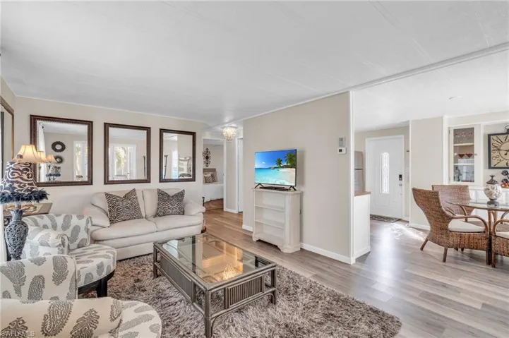 Living room leads to kitchen and dining area