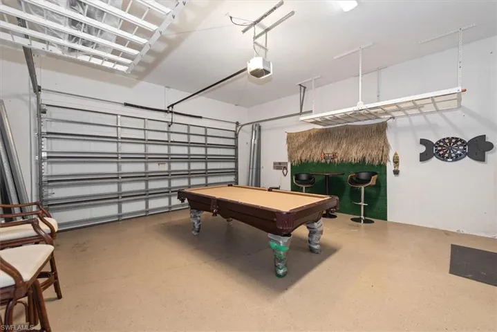 Rec room with a garage and pool table