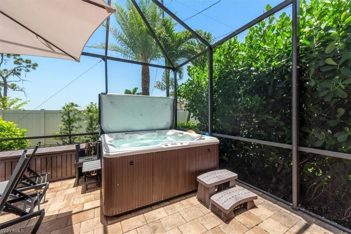 Sunroom / solarium featuring a jacuzzi