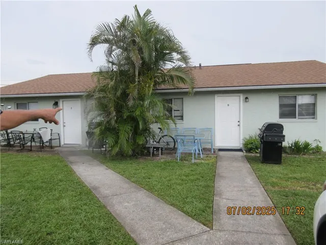From left to right Units C & D a front yard, stucco siding, and a patio area
