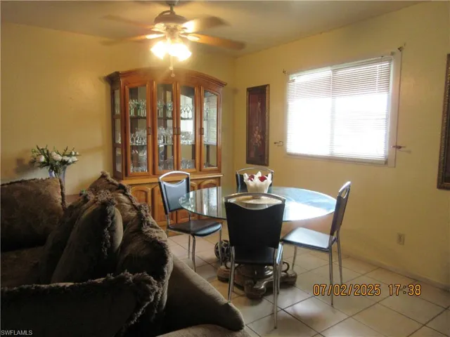 Dining area featuring light tile patterned floors and a ceiling fan