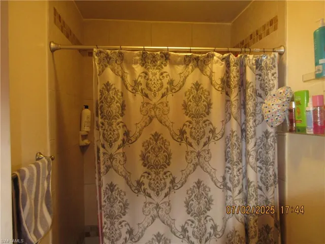 Bathroom featuring a shower with curtain
