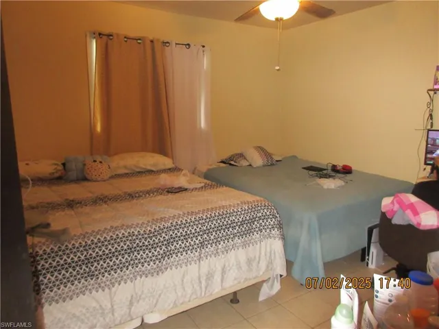 Tiled bedroom with ceiling fan