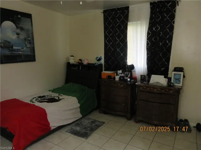 Bedroom featuring light tile patterned floors