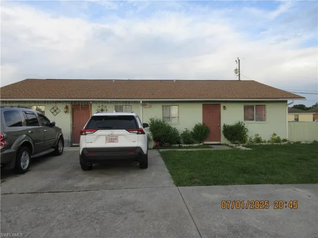 featuring a front lawn, a shingled roof new 2 yrs ago, circular driveway, and stucco siding