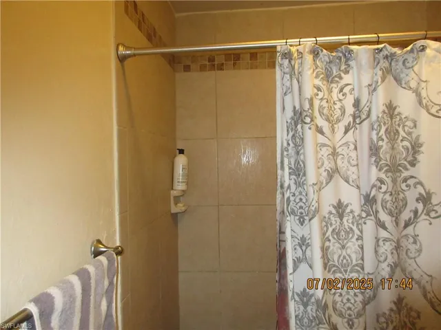 Bathroom featuring a shower with shower curtain
