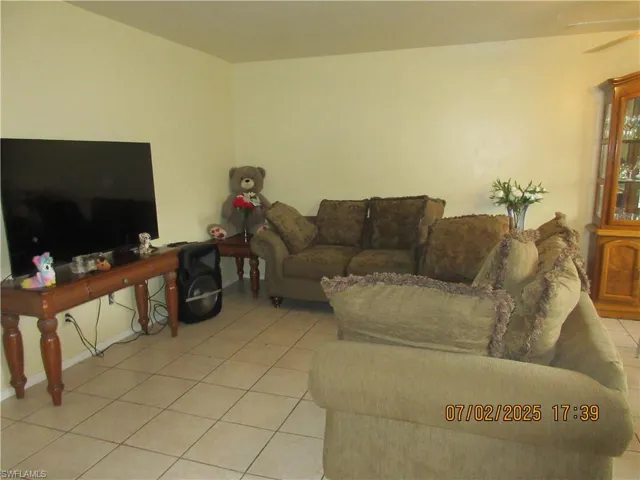 Living room with light tile patterned floors