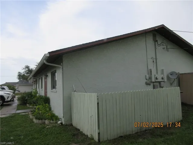 View of side of home with stucco siding