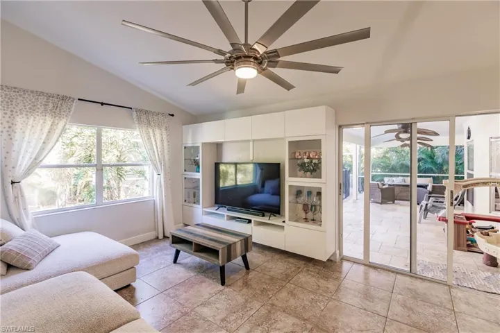 Living room with vaulted ceiling and ceiling fan