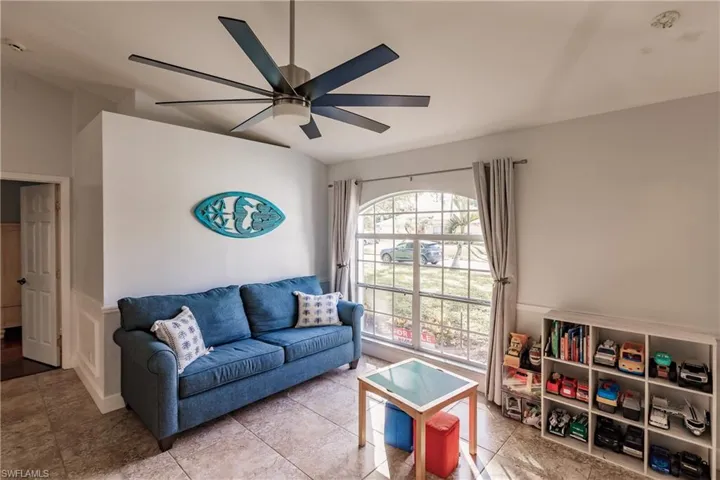 Den featuring ceiling fan
