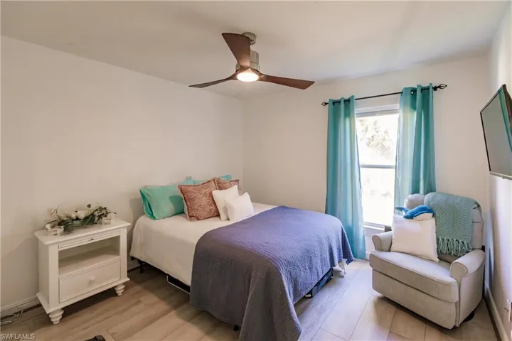 Bedroom with light hardwood / wood-style flooring and ceiling fan