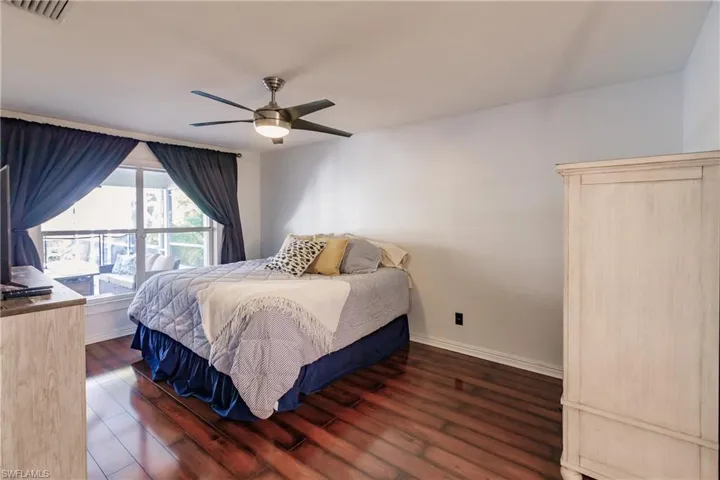 Bedroom featuring ceiling fan and dark hardwood / wood-style floors