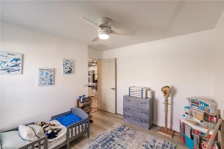 Bedroom featuring ceiling fan and light wood-type flooring