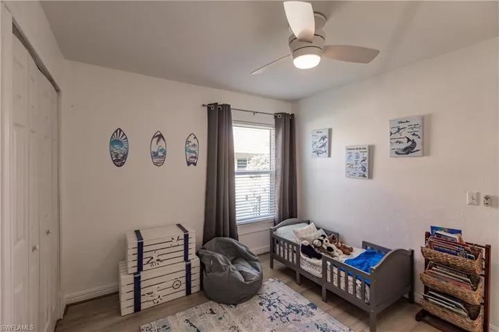 Bedroom featuring ceiling fan, a closet, and light hardwood / wood-style floors