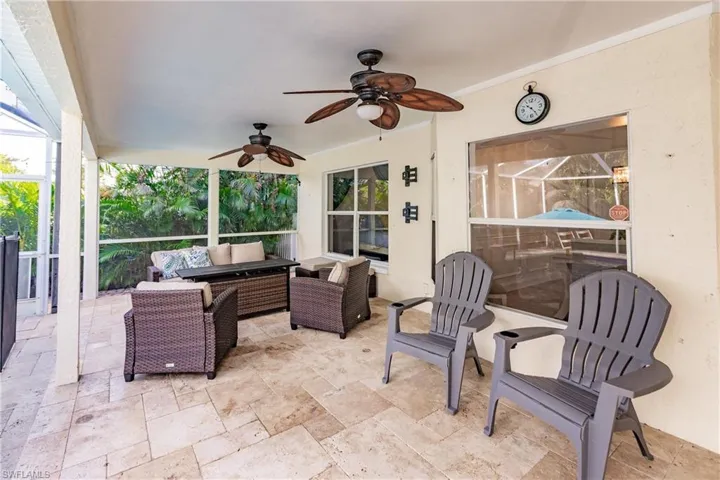 View of patio with outdoor lounge area and ceiling fan