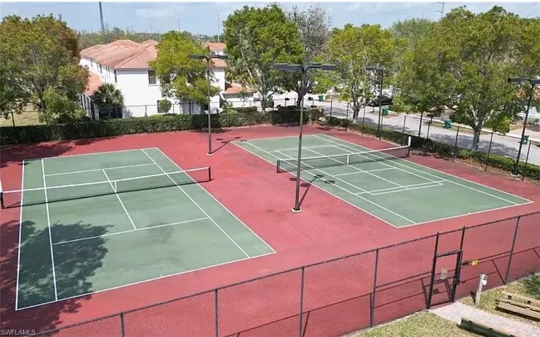 View of tennis court with community basketball court