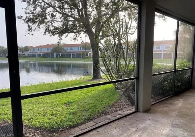 Unfurnished sunroom with a water view