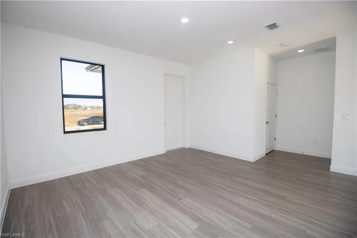 Bedroom featuring a closet and dark vinyl-style flooring