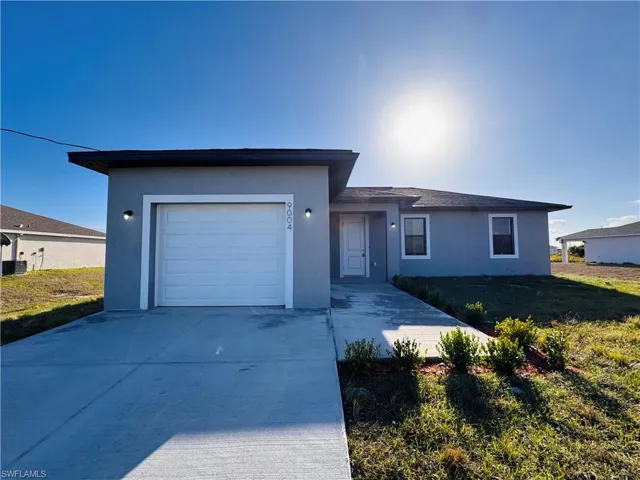 Single family house with a garage and a front lawn