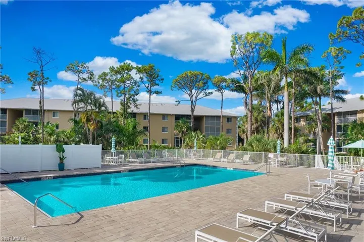 Community pool with fence and a patio