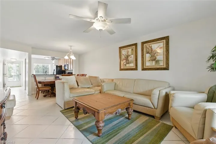 Living room featuring a ceiling fan and light tile patterned flooring