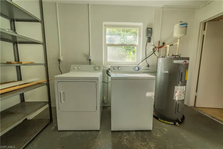 Laundry area featuring washing machine and clothes dryer and water heater