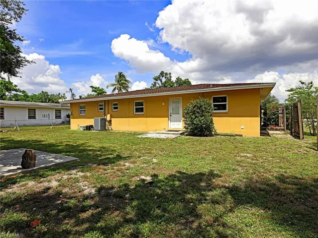 View of front of property featuring a patio area, central AC, and a front yard