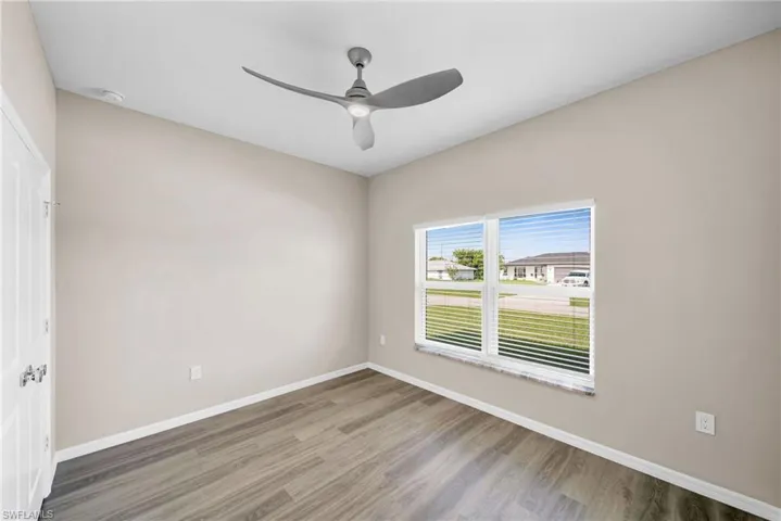 Unfurnished room featuring ceiling fan and wood-type flooring