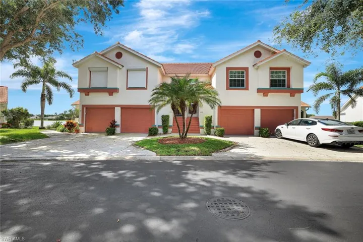 Mediterranean / spanish house with stucco siding, driveway, an attached garage, and a tile roof