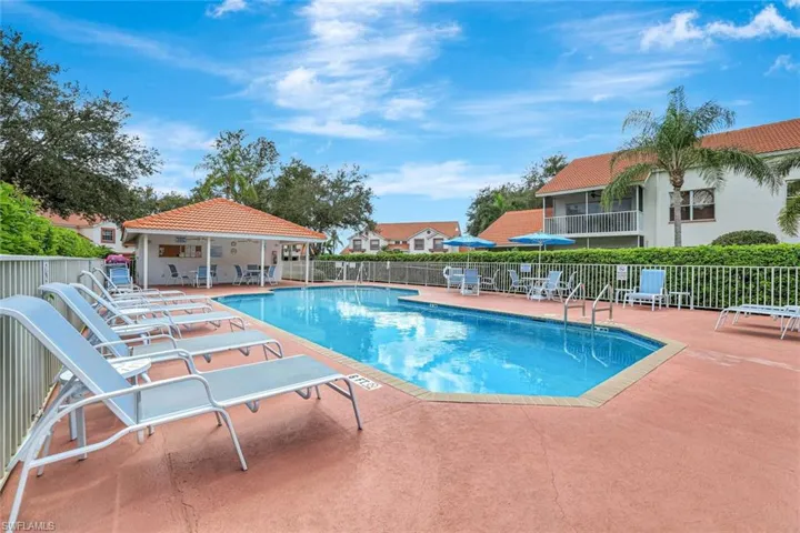 Community pool featuring a patio and a residential view