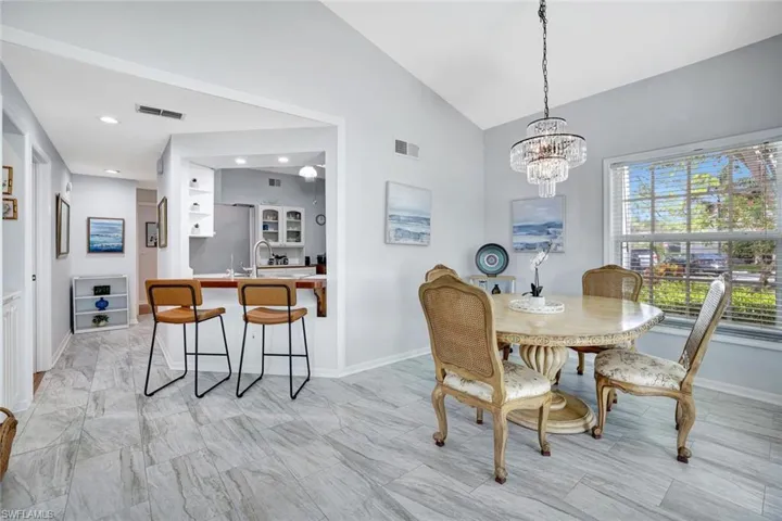 Dining space with vaulted ceiling and a chandelier